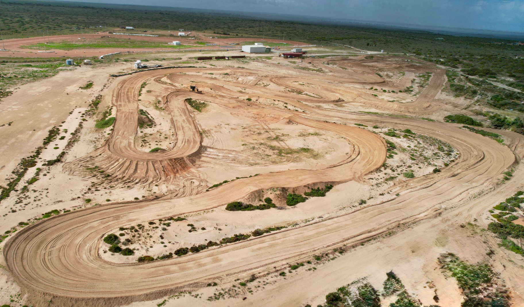 Aerial view of a club motocross track with shaped berms and jump faces